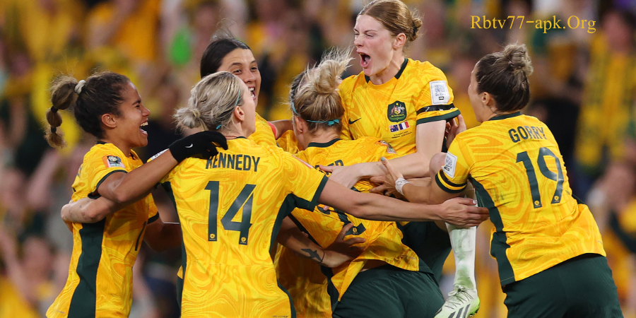 Australian women’s soccer team players in yellow jerseys celebrating a goal together with joy and excitement during a match — Rbtv77-apk.org.